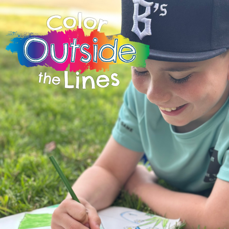 Color Outside the Lines contest showing a young boy drawing a picture for the cover