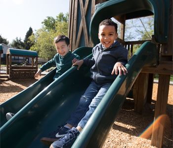 Two kids on the slide at Hap Magee Park