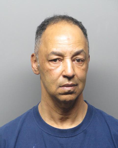 Photo of Ramon Pruitt, wearing dark navy shirt standing before a grey background