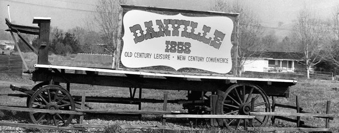 A black and white photo of an old wagon and a sign for Danville dated 1858